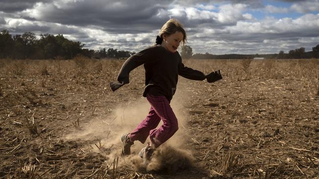 Heidi Taylor, 7, kicks up dust on the family farm outside Coonabarabran. Picture: Getty