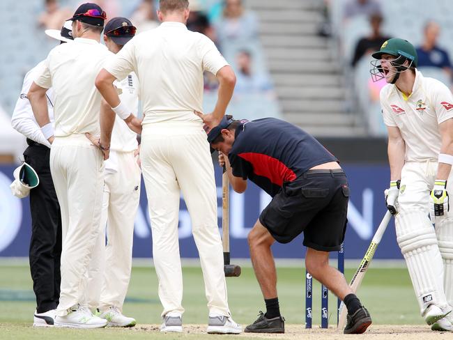 A groundsman takes a sledgehammer to the MCG pitch on day five. Picture: Michael Klein