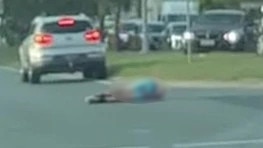 Connor McLeod, 25, lies in the road after being hit by a trail bike at Loganlea. Picture: Kiara Jasmine/Facebook