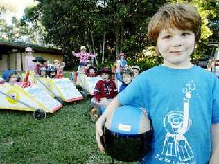 Oscar O’Connor, a student at the Cape Byron Rudolf Steiner School, prepares for Sunday’s Bangalow Billycart Derby as his schoolmates test some of the spare billycarts made by his dad, Lance. Jay Cronan