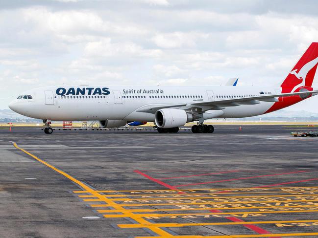 An arriving Qantas Airbus A330 aircraft taxis at Auckland international airport on the first day of New Zealanders returning from Australia after the border reopened for travellers observing home self-isolation rules, on February 28, 2022. (Photo by DAVID ROWLAND / AFP)