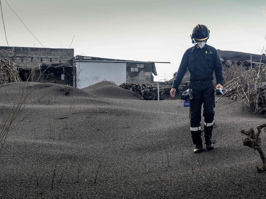 A member of the Spanish Military Emergency Unit monitors gas emissions. Picture: Luismi Ortiz/AFP