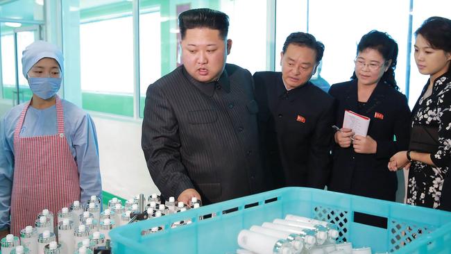 North Korean leader Kim Jong-un inspects the Pyongyang Cosmetics Factory, as his wife Ri Sol-ju (right) looks on. Picture: AFP/KCNA via KNS