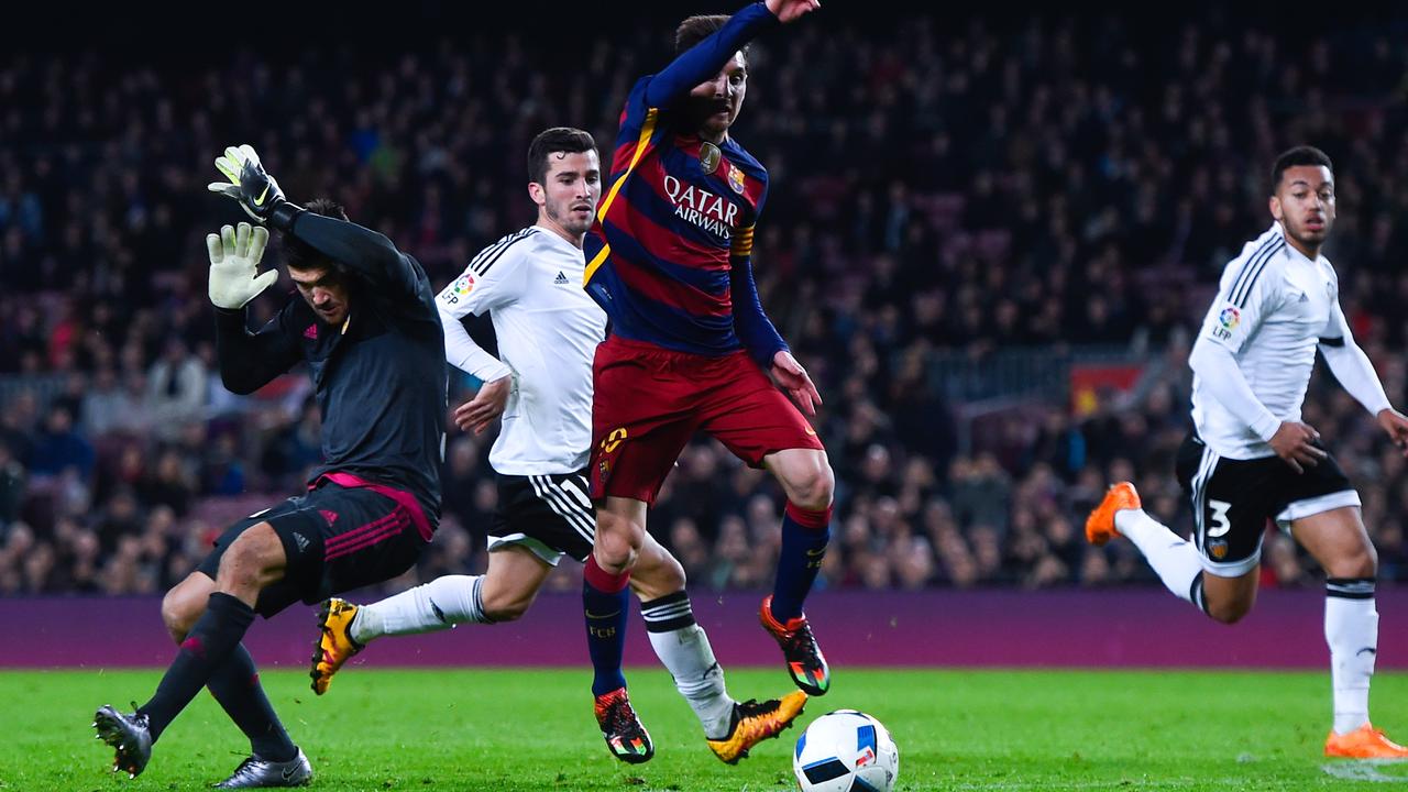 Lionel Messi goes past Maty Ryan during his time playing for Valencia