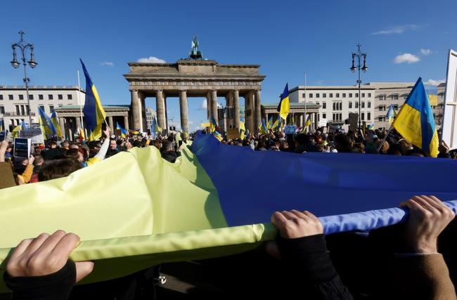 Thousands gathered in front of the Brandenburg Gate waving banners that read 'stand up for Ukraine' and 'arm Ukraine now'