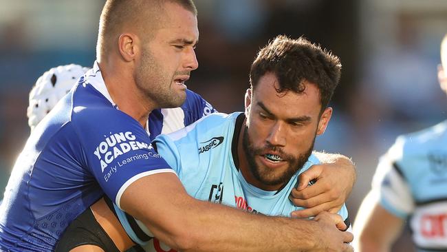 SYDNEY, AUSTRALIA - MARCH 15: Toby Rudolf of the Sharks is tackled during the round two NRL match between Cronulla Sharks and Canterbury Bulldogs at PointsBet Stadium on March 15, 2024, in Sydney, Australia. (Photo by Mark Metcalfe/Getty Images)