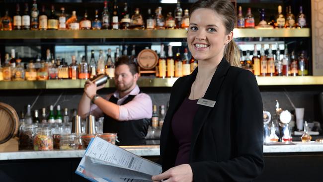 Melody Torbet, Adelaide Hilton Duty Manager in the Hilton's Collins Bar, with barperson Ryan Lenton making a cocktail in the background. STORY is about how to get a promotion. Melody has worked her way up in Hilton and is revealing her tips. Picture Campbell Brodie