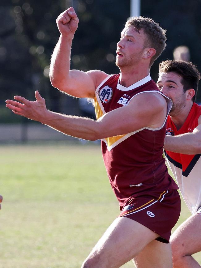 Lower Plenty’s Tom Keys fires off a handball. Picture: George Sal