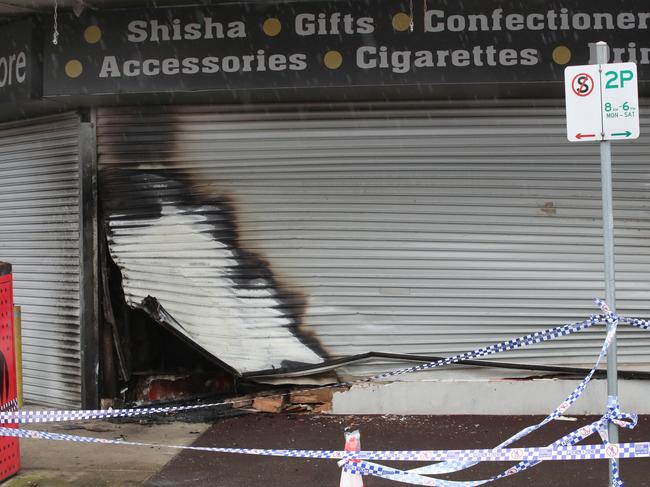 The scorched roller door at the entry to the Hadfield tobacco shop. Picture: David Crosling