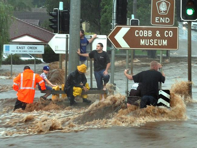 Kitchener Street intersection during the flash flooding in Toowoomba on Monday January 10, 2011. The boy in the blue cap is Blake Rice.Photo Adam Davies / The Chronicle