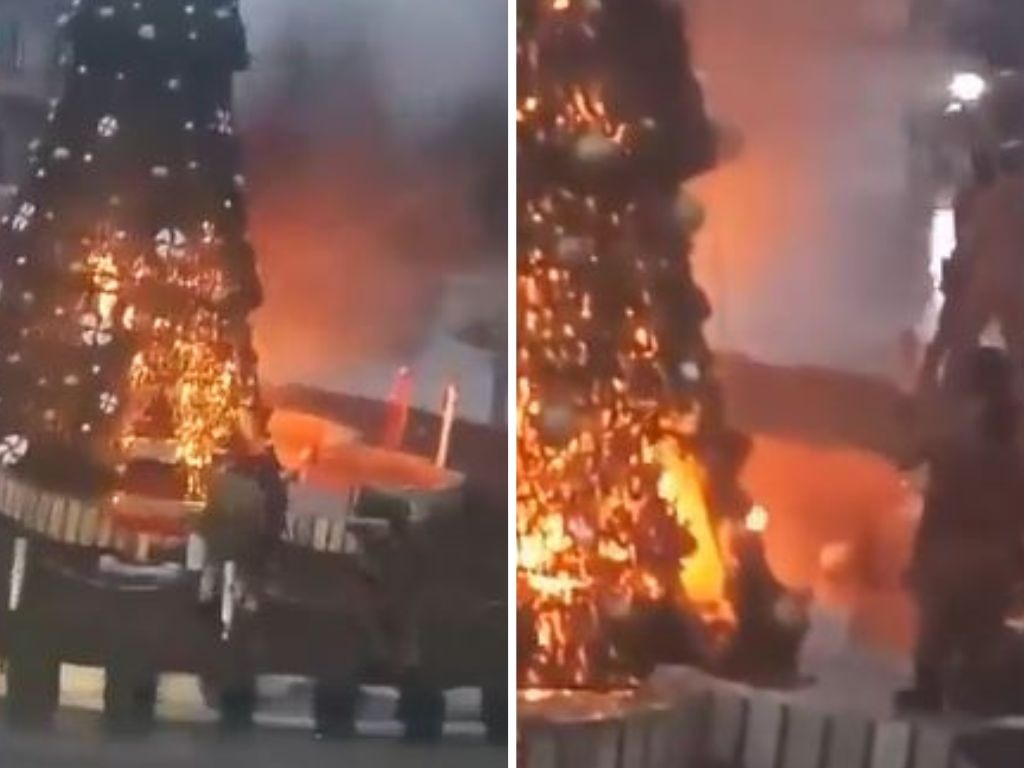 Masked men setting fire to the tree in the Suqaylabiyah’s main square. Picture: Twitter