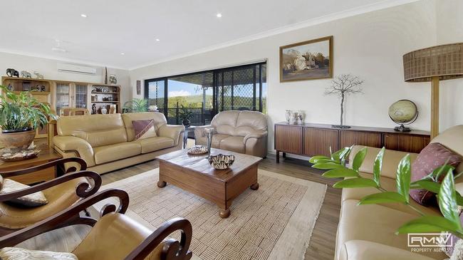 The home has soaring ceilings and three expansive living areas throughout.