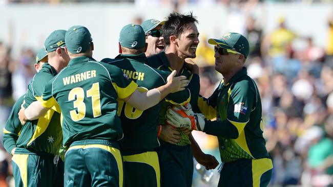 Australia celebrates after Johnson takes the wicket of Eoin Morgan.