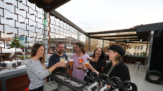 Last Night on Earth staff members Amanda Holloway, Aaran Woollams (owner), Brendan Coey, Bridgette Ford and Anita Kuiper toast its success. Picture Glenn Hampson