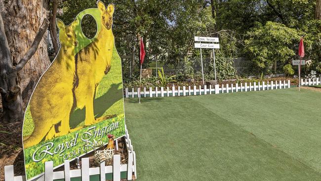 The course is surrounded by a white picket fence.