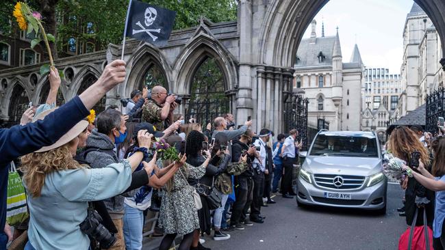 Fans of US actor Johnny Depp gather around his car as he is driven away form the High Court after the final day of his libel trial. Picture: Niklas Hallen/AFP