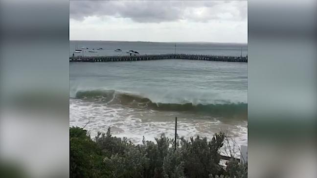 Wave crashes into eroded foreshore