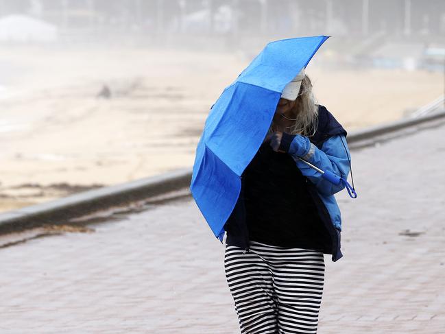 People out in the rain at Manly Beach today as Sydney has another day of wet weather, ahead of a minimum 100mm in the next few days. Picture: Tim Hunter.