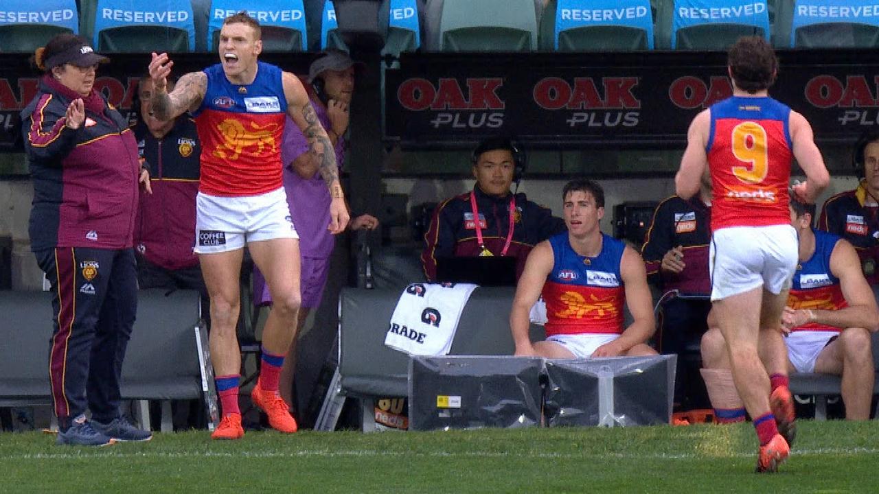 Brisbane's Mitch Robinson stands up for Lachie Neale as Port Adelaide’s Cam Sutcliffe comes off the ground in Adelaide.