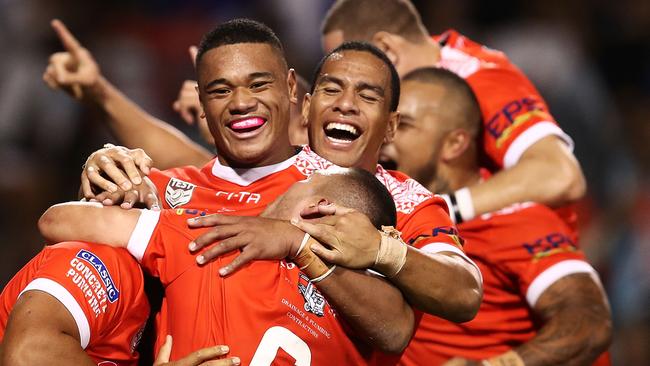 Leilani Latu of Tonga celebrates with team mates after scoring the match winning try against Fiji.