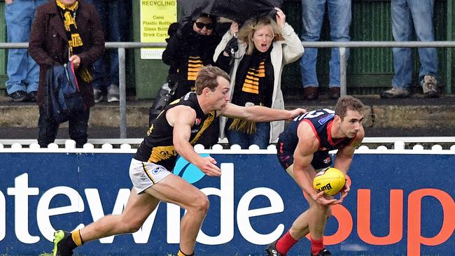 Norwood's Ed Smart marks in front of Glenelg's Jack Yates. Picture: Tom Huntley