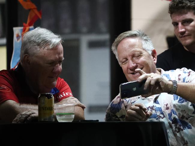 Australian cricket great Ian Healy shows Barrier Reef Big Bash boss Kevin Maher a video on his phone at the Barrier Reef Big Bash grand final match between the Piccones Badgers and the Twomey Schrieber Thunder was delayed by over two hours due to rain. Picture: Brendan Radke