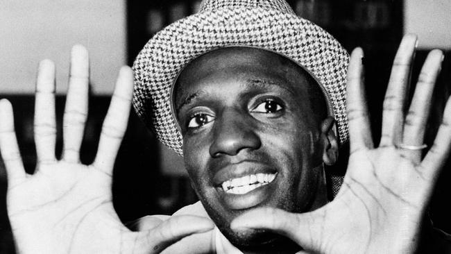 Meadowlark Lemon shows off his large hands on arrival in London for a tour in 1959. Picture: AP