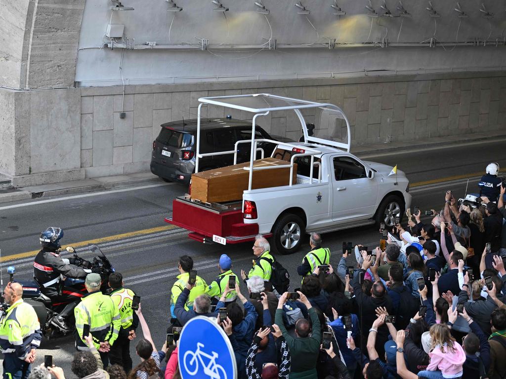 People gather along the road as the coffin of late Pope Francis is transported from St Peter's Basilica to Santa Maria Maggiore Basilica, in the “popemobile”. Picture: AFP