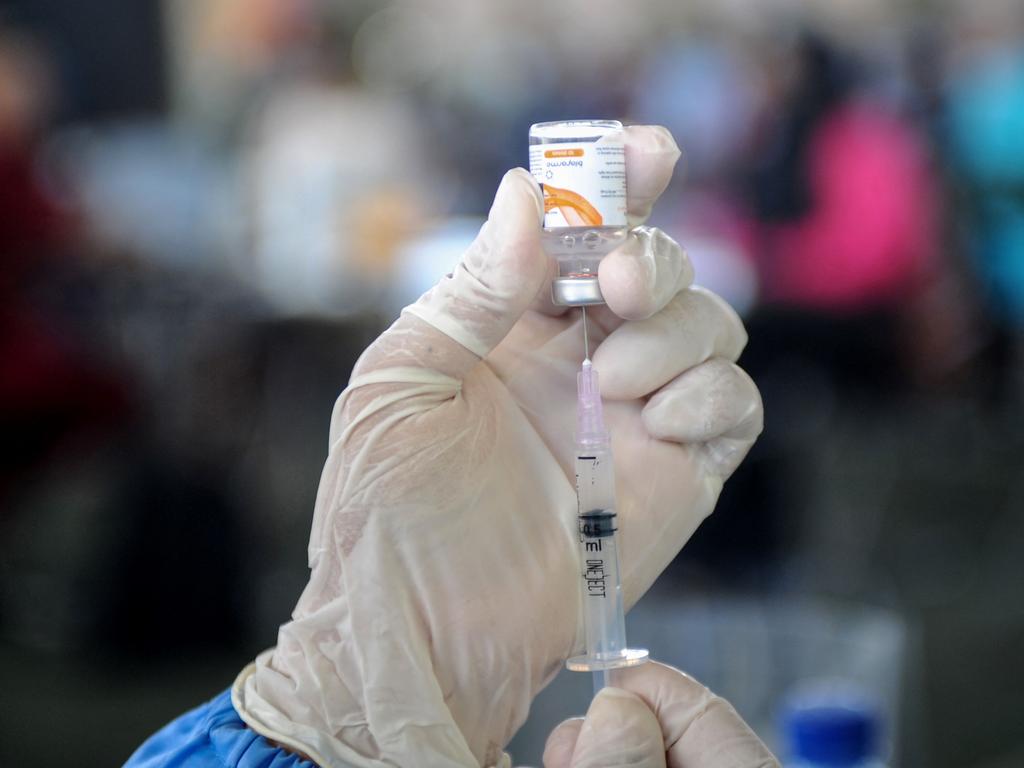 A health worker prepares the AstraZeneca vaccine.