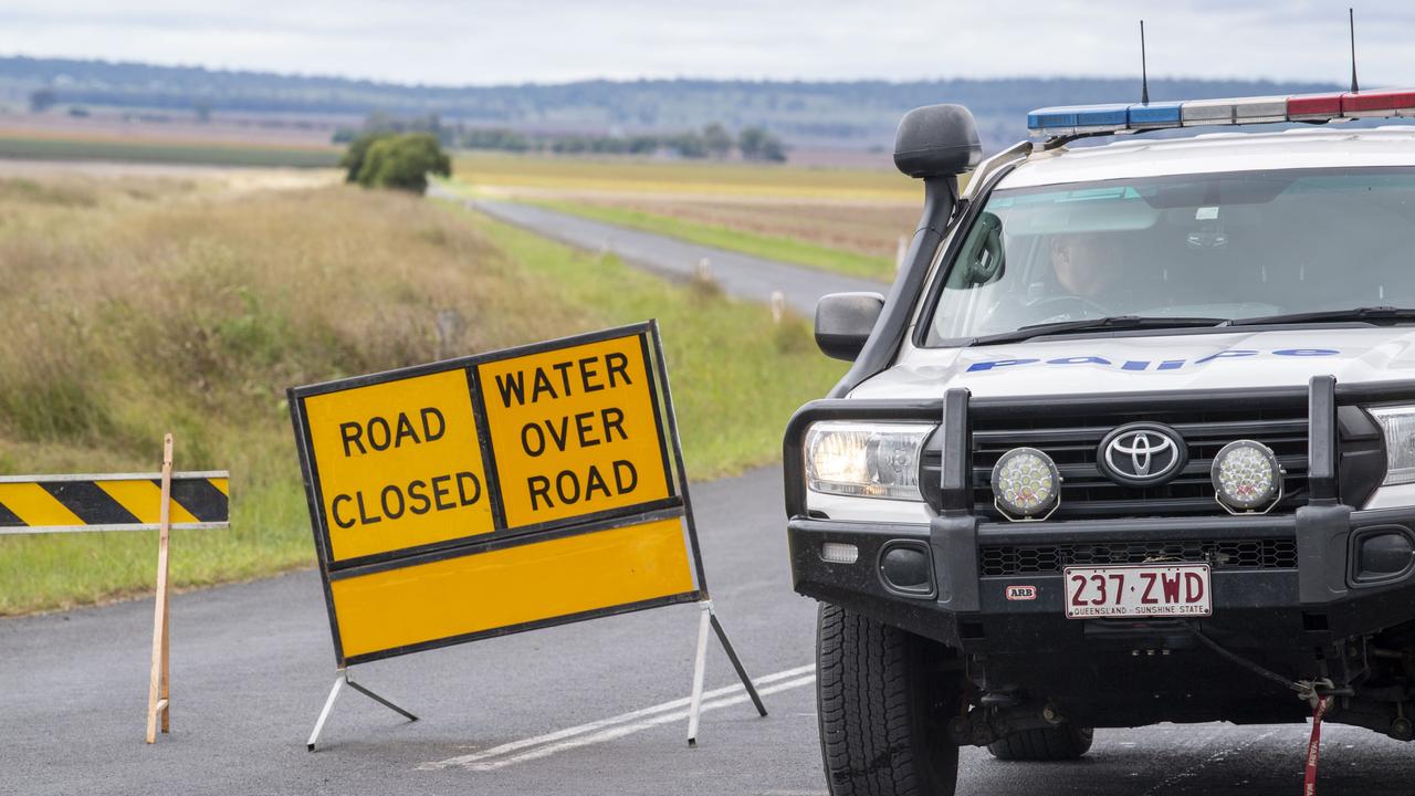 Police on Pittsworth-Clifton Road where a man lost his life in flood waters at North Branch on Monday, March 28. Picture: Nev Madsen.