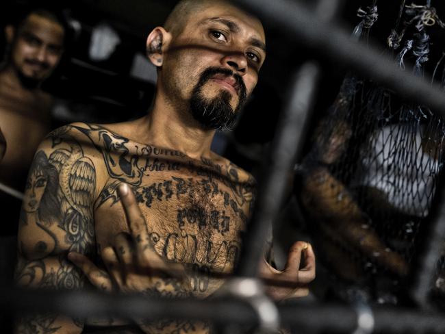 A local leader of the Mara Salvatrucha gang (MS-13) shows a gang hand sign in an El Salvador detection centre in 2014. Picture: Jan Sochor/Getty.
