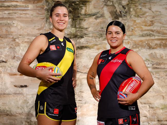 MELBOURNE, AUSTRALIA - MAY 30: Ellie McKenzie of the Tigers and Madison Prespakis of the Bombers pose for a photo during a photoshoot to announce that an AFLW match will be played for the first time in Darwin in the 2024 season at Pipemakers Park on May 30, 2024 in Melbourne, Australia. (Photo by Dylan Burns/AFL Photos via Getty Images)