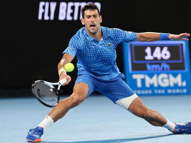 Serbia's Novak Djokovic hits a return against Bulgaria's Grigor Dimitrov during their men's singles match on day six of the Australian Open tennis tournament in Melbourne on January 21, 2023. (Photo by Martin KEEP / AFP) / -- IMAGE RESTRICTED TO EDITORIAL USE - STRICTLY NO COMMERCIAL USE --