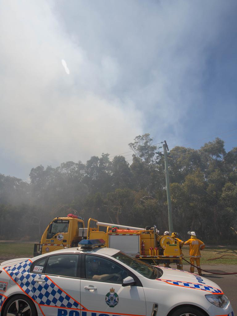 Firefigters work to contain a bushfire at the southern end of Peregian Beach on the border with Coolum Beach, Queensland, Wednesday, October 23, 2019. The fire started north of the Coolum High school and travelled north towards the beach. (AAP Image/Rob Maccoll) NO ARCHIVING