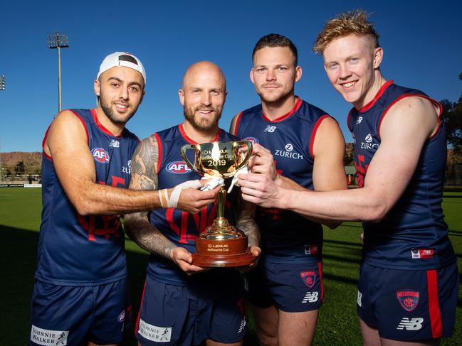 Melbourne Demons Christian Salem, Captain Nathan Jones, Steven May and Clayton Oliver give the cup a polish before the showdown against West Coast. Picture: Mark Stewart