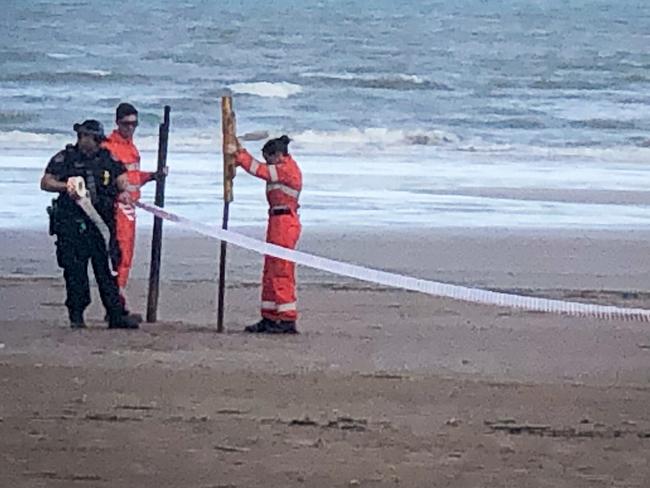 police and ses at the scene of the discovery of a body on casuarina beach