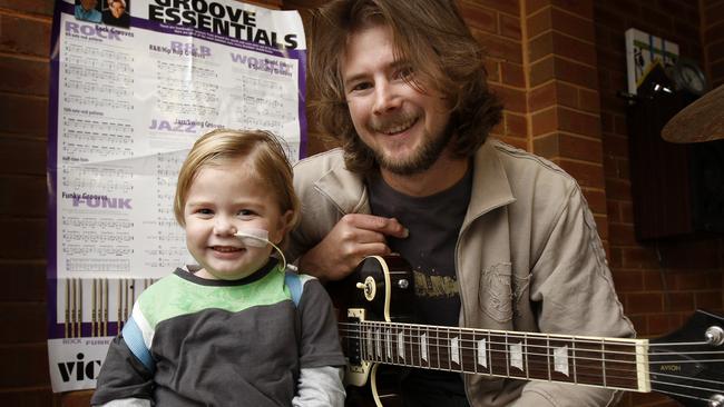 Zander Chugg with his dad Nick have a jam session at their Sunbury home. Zander is waiting for an intestinal transplant and is making the most of things while he waits. Picture: File