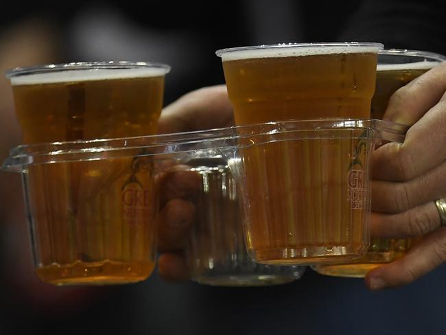 A fan is seen carrying beer before during the Round 9 AFL match between the St Kilda Saints and the Collingwood Magpies at Etihad Stadium in Melbourne, Saturday, May 19, 2018. (AAP Image/Julian Smith) NO ARCHIVING, EDITORIAL USE ONLY