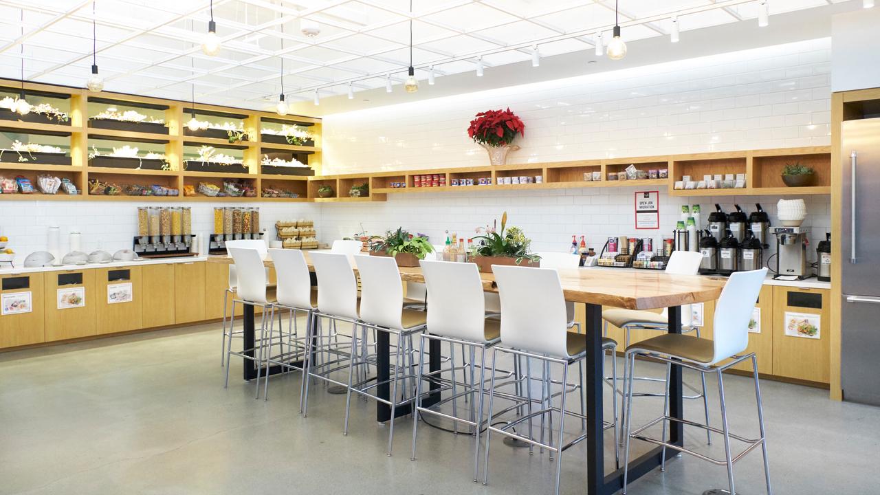 Rows of coffee machines and fridges packed with drinks sit next to baskets with the ‘snack of the month’.