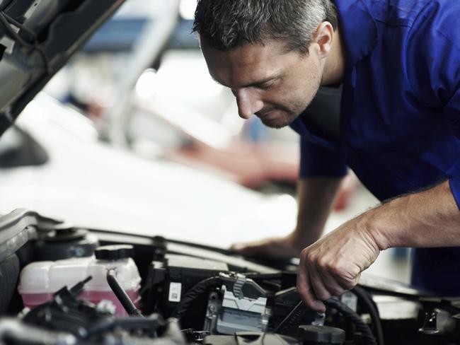 Closeup of an experienced mechanic servicing a car at his workshop - Copyspace Please credit istock