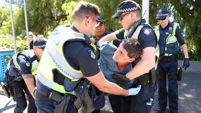 A homeless man is arrested under the Princes Bridge in Melbourne. The man had been abusing passers by before the police were notified. Picture: Alex Coppel.