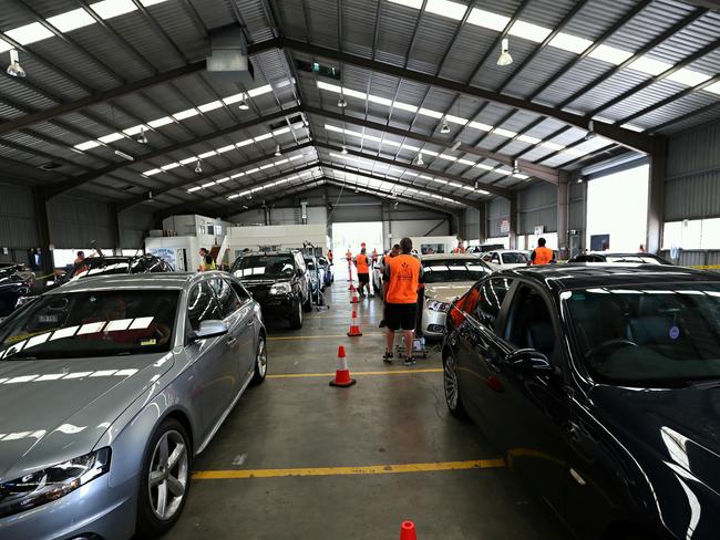 CMNEWS_Australian Insurance company Suncorp access damages to vehicle today in Fairfield Monday Dec.1st, 2014. Thousands of motor vehicle will be inspected by dozens of insurance companies over the next week after violent hail storm hit Brisbane late Thursday afternoon causing millions of dollars in damage. Pictures: Jack Tran / The Courier Mail