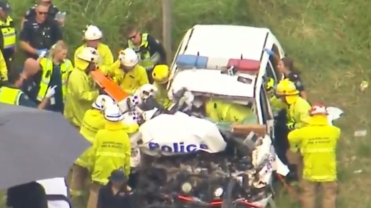 Emergency crews working to retrieve Senior Constable Tim Leonard from the vehicle after the crash. Picture: 9 News