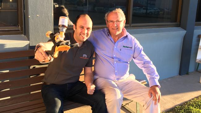 Exciting progress: Director and developer of Numnuts Robin Smith with the device, and his father David Smith, the inventor of Barbervax, in Armidale last week.