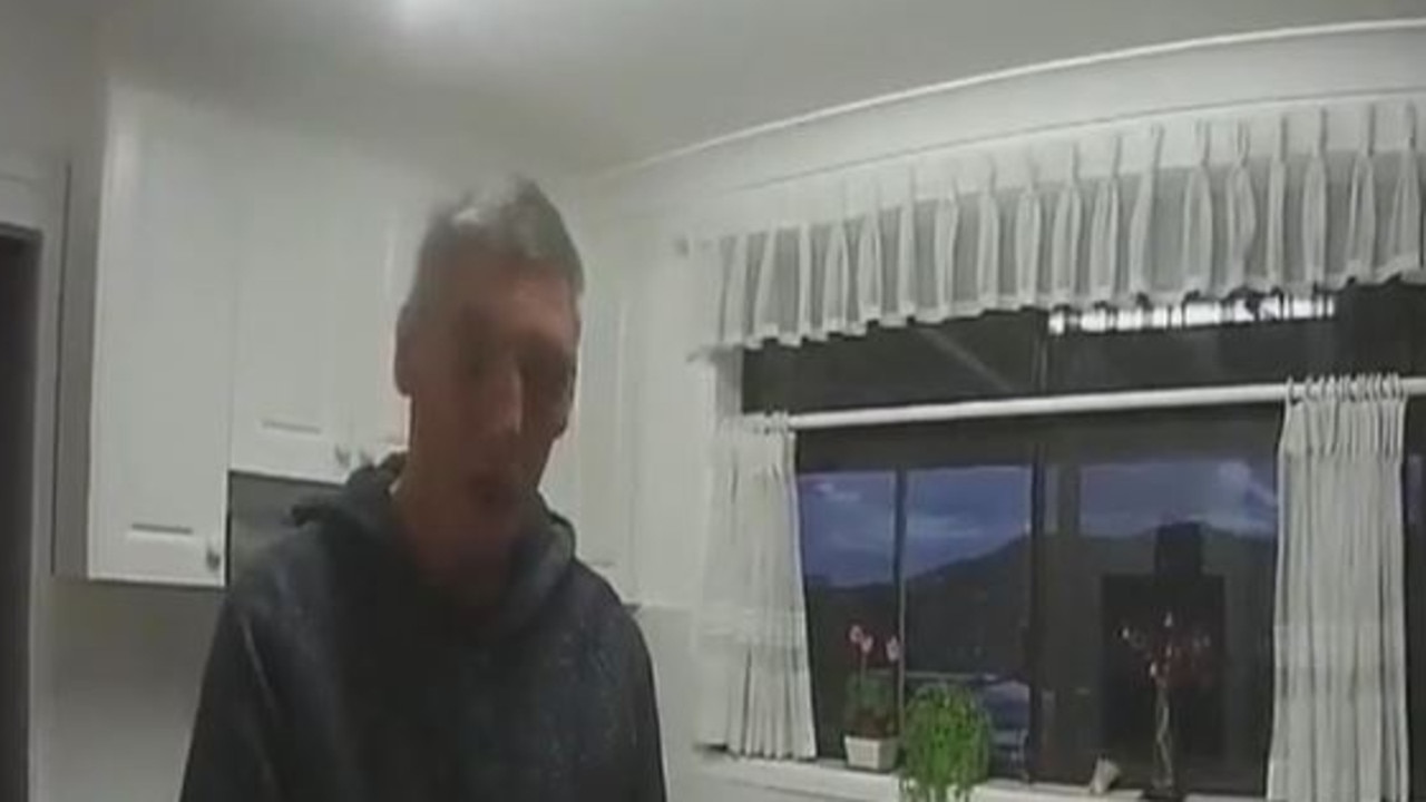 Mapp speaks to police at the home as his mum lies dead just metres away. Picture: NSW Police