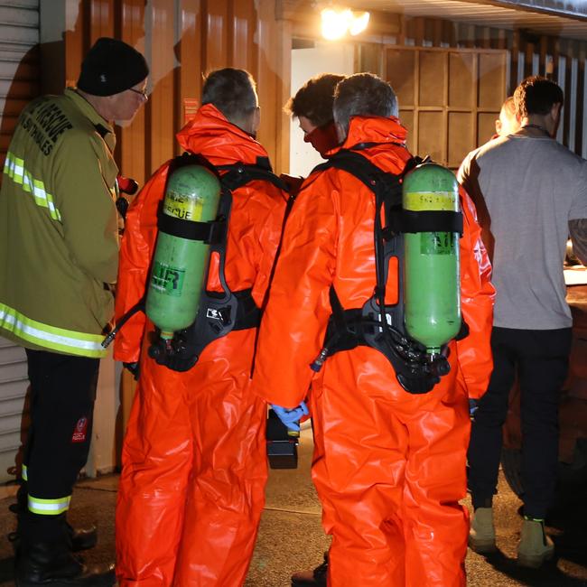 Specially equipped police prepare to enter the ‘cook’ house.