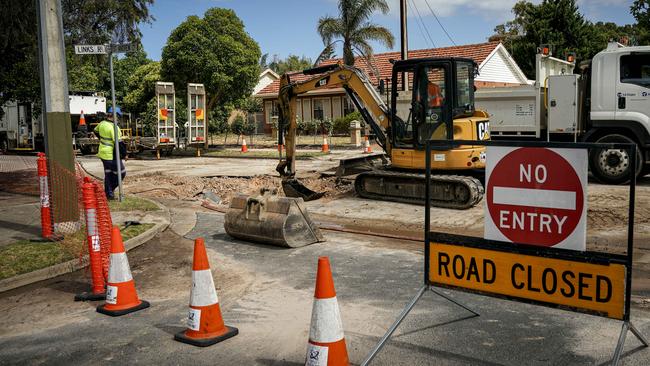 SA Water crews start repairs at the site where the sinkhole opened up in a Novar Gardens road and half swallowed a car overnight. Picture: Mike Burton