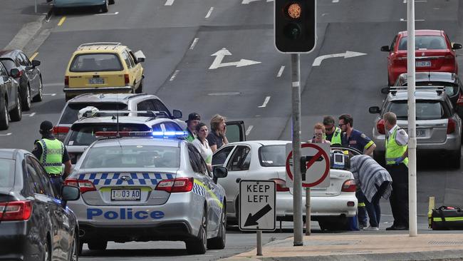 Tasmania Police and Ambulance attend a two-car crash on the corner of Davey and Harrington streets. Picture: LUKE BOWDEN