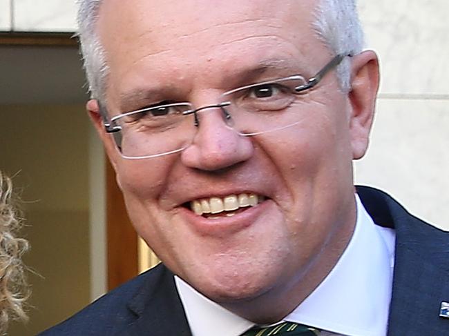 PM Scott Morrison  with Sri Lanka's Captain bowler Lasith Malinga signing a ball while attending the PM XI Cricket reception at Parliament House in Canberra. Picture Kym Smith