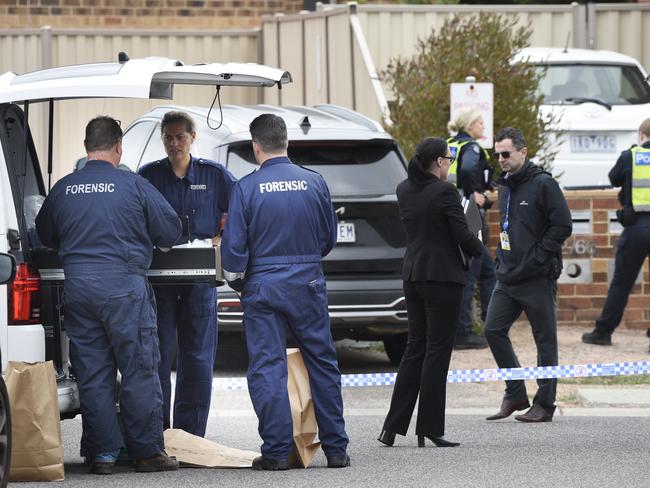 Police probe the fatal stabbing. Picture: Andrew Henshaw